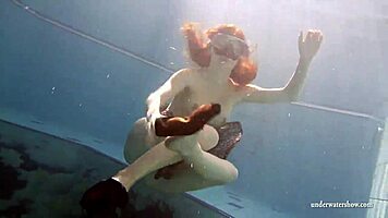 big tits brunette mia strips naked underwater in the pool, showing off her shaved body