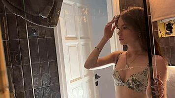 Petite College Cheerleader Removes Panties in Bathroom and Lifts Miniskirt