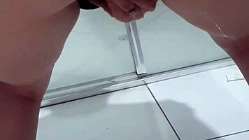 Teen bends over for juicy squirt in bathroom stall