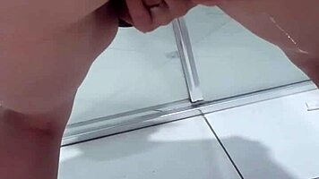 Teen bends over for juicy squirt in bathroom stall