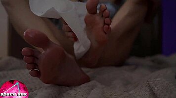 Teen girl plays with oiled feet in close-up fetish