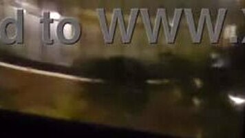 Milf masturbates in front of hotel window.