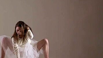 Blonde gymnast just casually showing off moves in a naked workout.