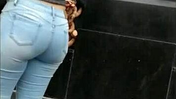 teen latina with tight jeans showing off her curves in a voyeur scene