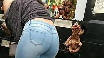 teen latina with tight jeans showing off her curves in a voyeur scene