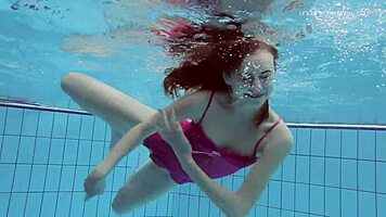 Anna netrebko teases in bikini while swimming in the pool, showing off her petite figure.