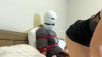 Masked dude receives footjob and bondage treatment as slave