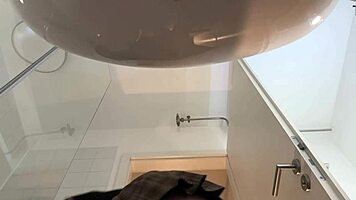 Hot blonde babe with big tits and ass strips in pantyhose and heels in bathroom