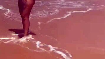 Young African Woman Flashes On The Beach