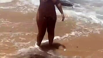 Young African Woman Flashes On The Beach