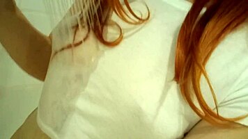 redhead teen 18+ bathing in the tub, the water covering her body partially