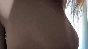 woman caresses her milky tits until she orgasms