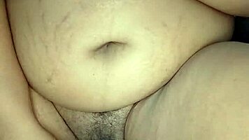 Is this ebony woman masturbating in her room alone?