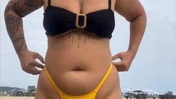 Young african woman in tight yellow bikini at usa beach