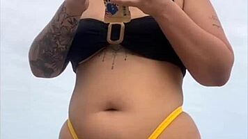 Young african woman in tight yellow bikini at usa beach