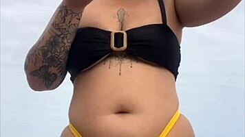 Young african woman in tight yellow bikini at usa beach