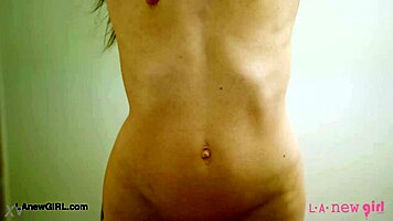 Beautiful brunette enjoys effortless shower routine with petite charm