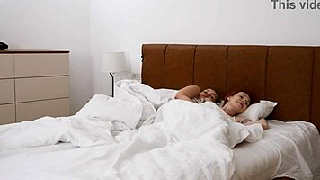 Two naughty women share bed with guy in steamy hotel escapade