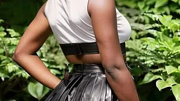 ebony beauty flashes big natural tits behind leather skirt outdoors