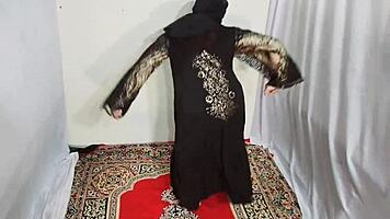 Arabic beauty in black hijab sways hips and bounces curves to exotic beats