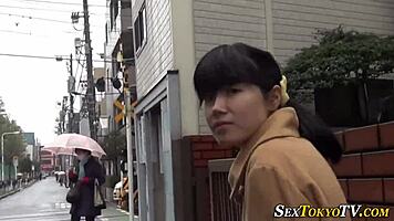 curious asian babe lifts skirt revealing panties outdoors