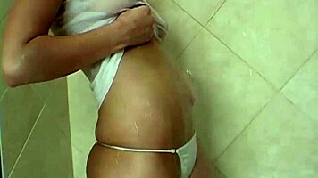 Sweet teen teases wet nipples pussy in steamy shower?