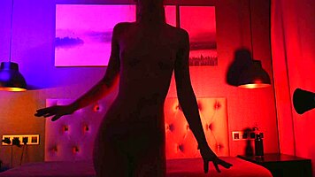 sexy blonde bombshell dances teasing her curves in shadows stripping slow and seductive