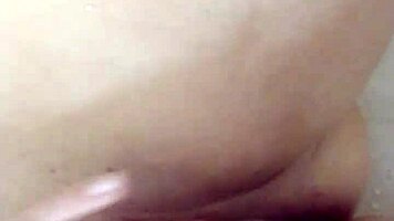 Teen brunette teases wet pussy close-up in steamy shower solo play