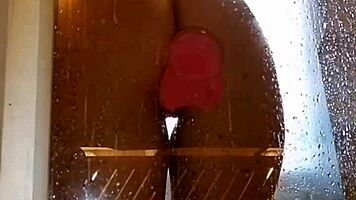 Appetizing ass girl spreads wide for pink toy fun in steamy shower.