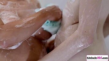 passionate milf licks and fingers young shaved pussy in steamy shower tribbing