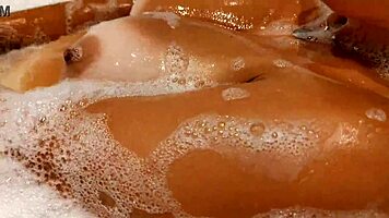 Tanned Big Tits Beauty Teases Pussy in Bathroom