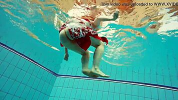 hairy brunette marketa swims underwater in tight pool