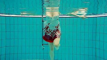 hairy brunette marketa swims underwater in tight pool