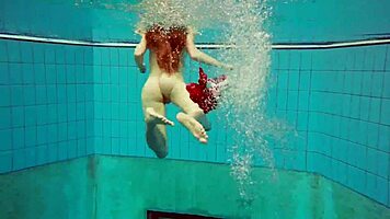 hairy brunette marketa swims underwater in tight pool