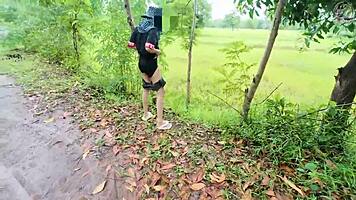 Thai babe hikes skirt flashing shaved pussy outdoors in garden