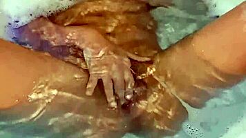 Latina babe fingers herself sensually to explosive bath orgasm