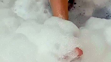 Latina babe fingers herself sensually to explosive bath orgasm