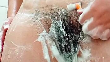 Young Brunette Spreads Hairy Pussy Close-Up Before Shaving It Smooth