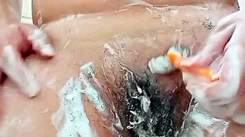 Young Brunette Spreads Hairy Pussy Close-Up Before Shaving It Smooth