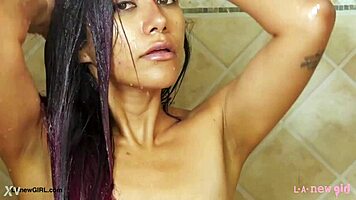 elegant brunette milf steps out of steamy shower glistening wet
