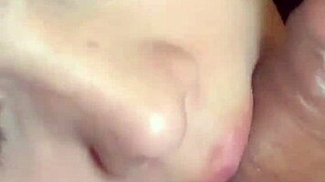 Sexy latina babe kneels close-up sucking cock with spit in homemade bedroom scene