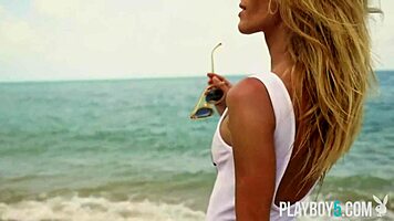 Petite blonde Cara Mell seductively strips nude on sun-kissed beach