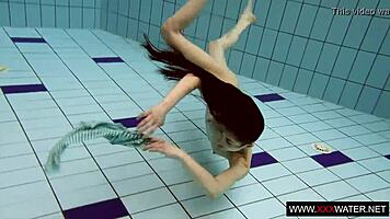 Brunette with long hair bathes underwater