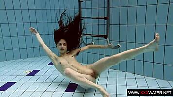 Brunette with long hair bathes underwater