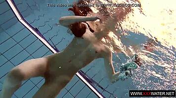 Brunette with long hair bathes underwater
