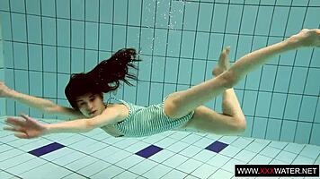 Brunette with long hair bathes underwater