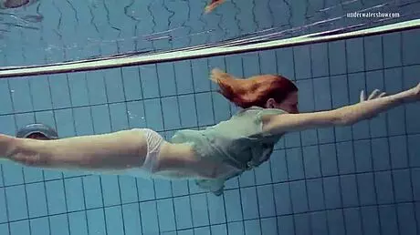 Nastya volna swims gracefully underwater like a wave in the pool