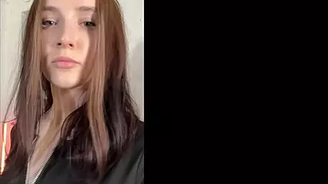 Cheeky trainer guides two students in yoga session