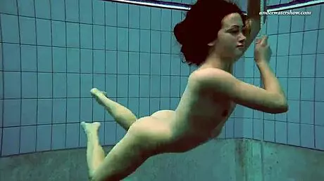 Petite 18+ brunette pornstar Alla swims naked in the hot pool, showing off her horny tits and ass while smoking