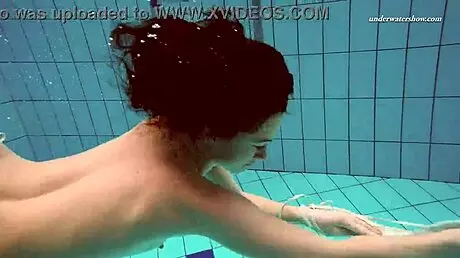 Petite 18+ brunette pornstar Alla swims naked in the hot pool, showing off her horny tits and ass while smoking